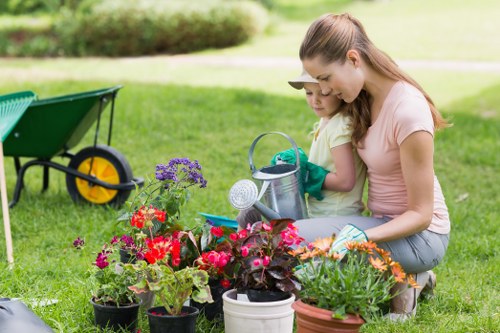 Gardeners following safe working practices during outdoor maintenance